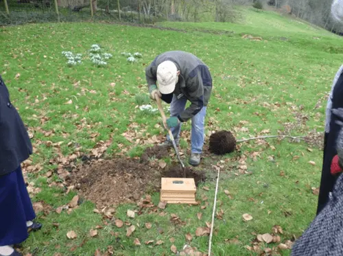 the ashes of robert eric hill 1917 2002 being buried under a new oak tree at prior park gardens in 2011
