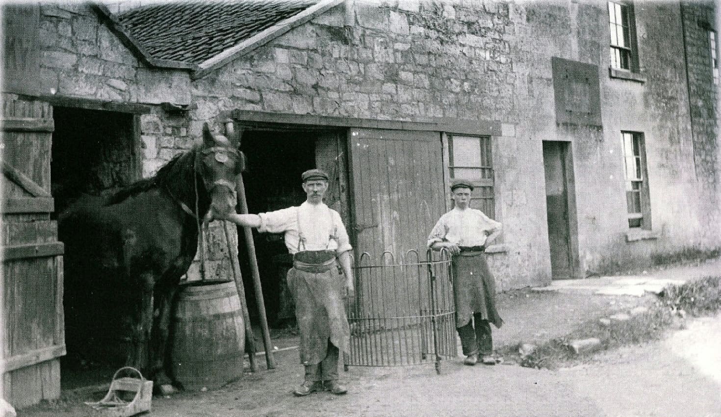 Smithy opposite the Cross Keys 1930s with horse and people