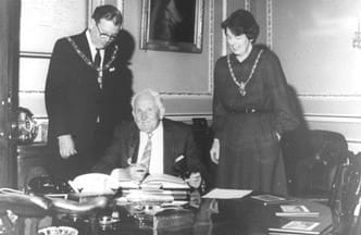 Albert Coles receiving his Mayors Medal from CllrTony Rhymes and his wife for 50 years of service with the company